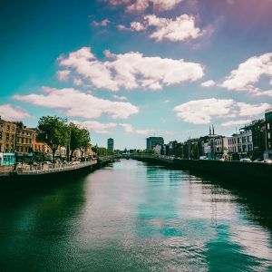 Beautiful river view of Dublin cityscape with reflections and vibrant sky.